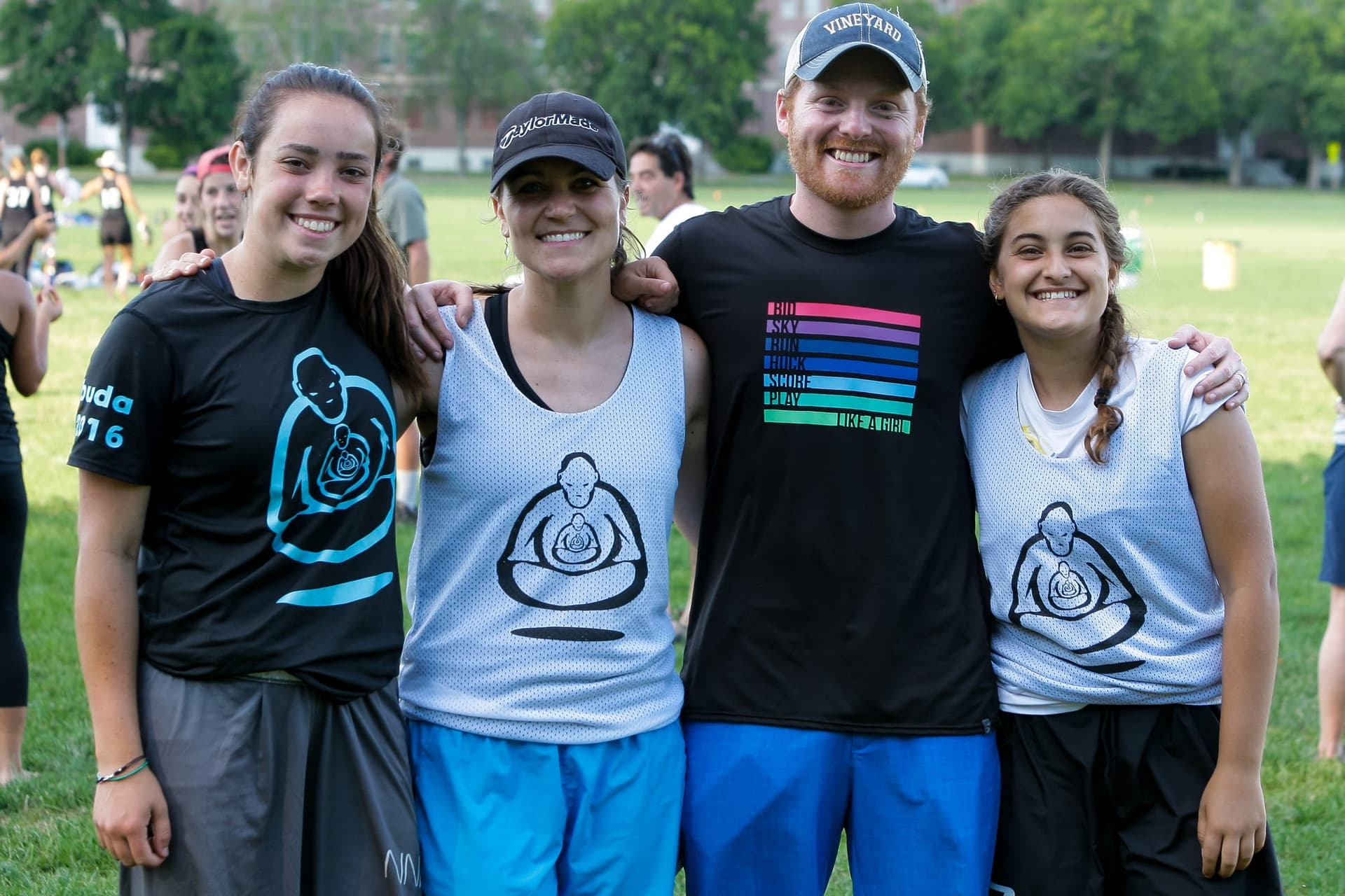 Four smiling players arm-in-arm in BUDA jerseys at Boston Invite